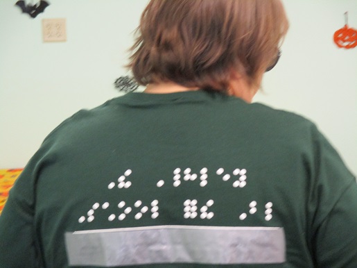 Teresa Mealer's T-shirt has Braille writing on the back.